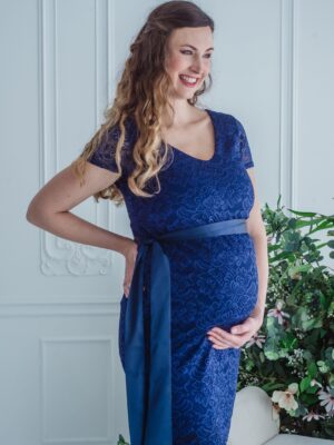 Woman in maternity lace dress